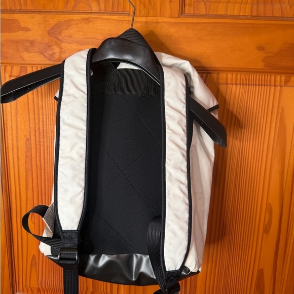 66 North Iceland Cream faux leather Backpack w zippered front pocket.
